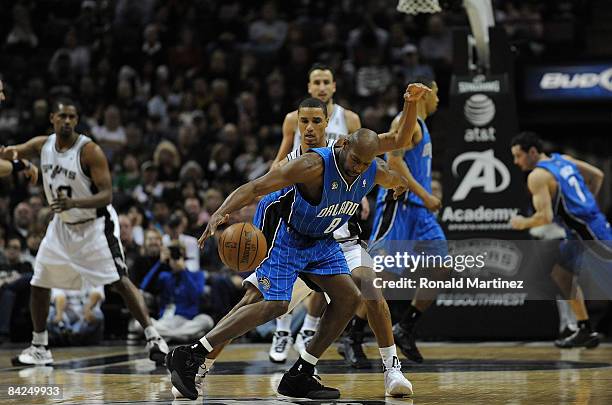 Guard Anthony Johnson of the Orlando Magic dribbles the ball against George Hill of the San Antonio Spurs on January 11, 2009 at AT&T Center in San...