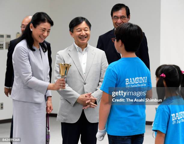Crown Prince Naruhito and Crown Princess Masako talk with participants after watching hand bell performance at Oji City Culture & Walfare Center on...