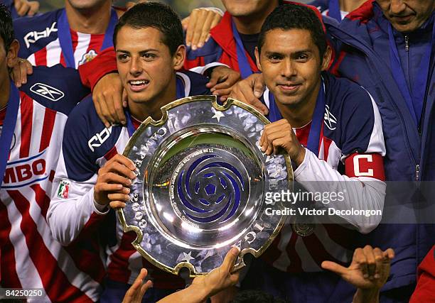 Captain Ramon Morales and Javier Hernandez of CD Chivas de Guadalajara hold up the InterLiga trophy for a photo after defeating Morelia 4-2 on...
