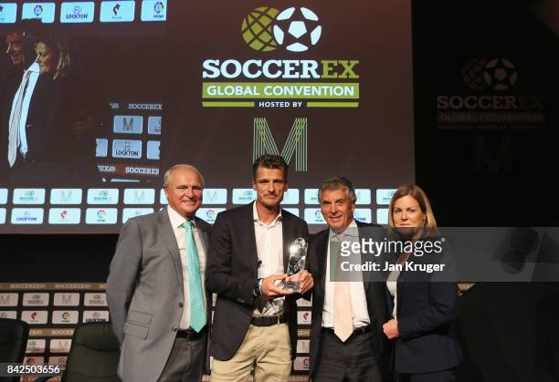 Wim Jonk , Cruyff Football CEO, accepts the Duncan Revie award on behalf of Johan Cruyff of the Netherlands with Tony Martin , Soccerex Chairman,...