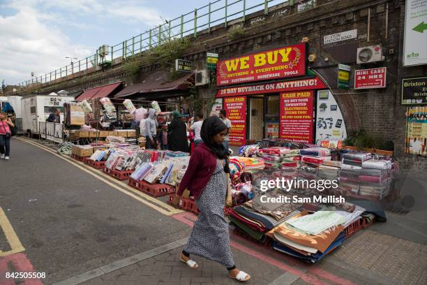 Lady wearing a headscarf walkign through in Brixton Market along Brixton Station Road on 23rd July 2017 in South London, United Kingodm