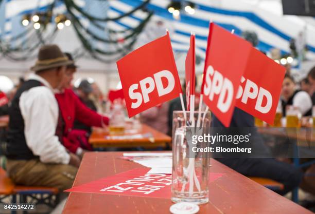 Party political flags sit on a beer table in a masskruege glass during an election campaign event with with Social Democrat Party candidate for...