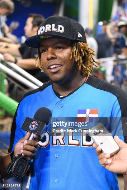 Toronto Blue Jays prospect Vladimir Guerrero Jr. #27 of the World Team talks with reporters prior to the 2017 SiriusXM All-Star Futures Game at...