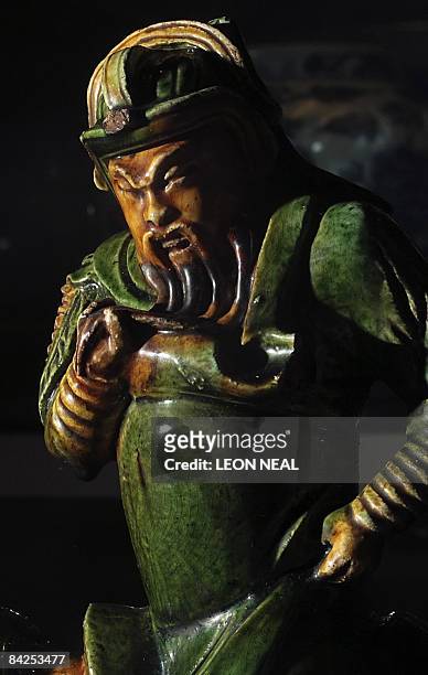 Ming Dynasty roof tile depicting legendary General and God of War Guan Yu is displayed at the "China: Journey to the East" exhibition at the British...