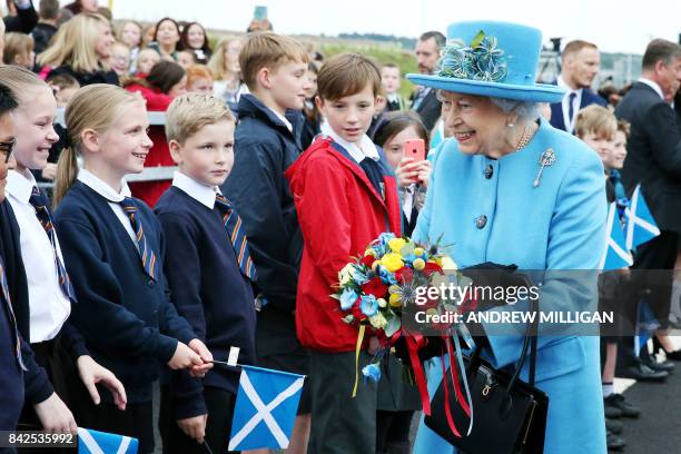 Queen Elizabeth II meets school children during the official opening ceremony for the Queensferry Crossing, a new road bridge spanning the Firth of...