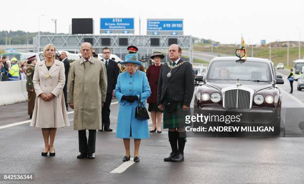 Queen Elizabeth II and Prince Philip, Duke of Edinburgh stand during the official opening ceremony for the Queensferry Crossing, a new road bridge...