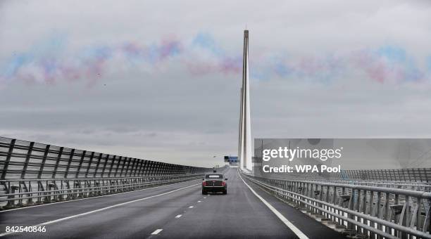 Queen Elizabeth II and Prince Philip, Duke of Edinburgh are driven across the Queensferry Crossing as the Red Arrows fly past, during the official...