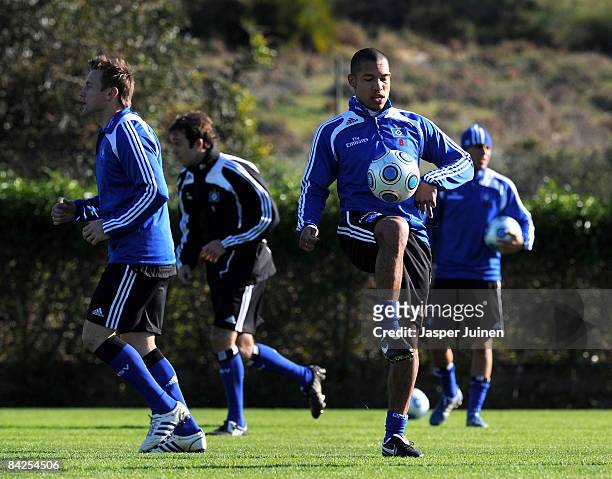 Nigel de Jong of Hamburger SV juggles the ball backdropped by his teammates during his team's training session on January 12, 2009 in La Manga, Spain.