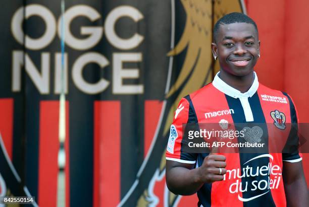 Nice football club's new recruit French midfielder Nampalys Mendy poses with his new jersey during the official presentation of the club's new...