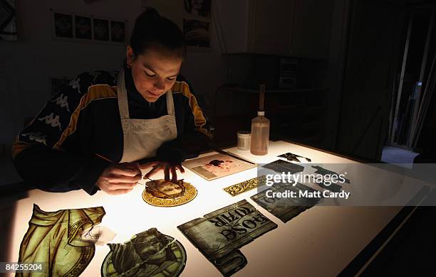 Apprentice glazier Vicky Burton works on some pieces of stained glass that are being repaired as part of an ongoing restoration project at Salisbury...