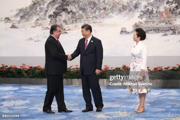 Tajikistan's President Emomali Rakhmon greets Chinese President Xi Jinping an his wife Peng Liyuan prior to the dinneron September 4, 2017 in Xiamen,...