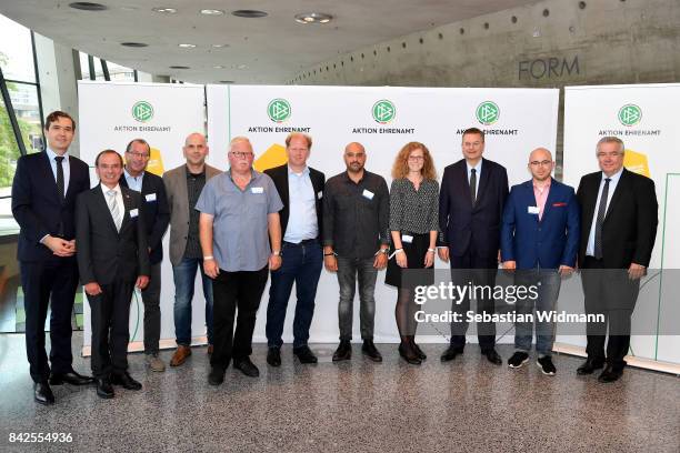 President Reinhard Grindel, DFB general secretary Dr. Friedrich Curtius and DFB vice president Peter Frymuth pose with members of the Football...