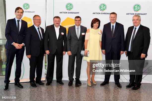 President Reinhard Grindel, DFB general secretary Dr. Friedrich Curtius and DFB vice president Peter Frymuth pose with members of the Football...