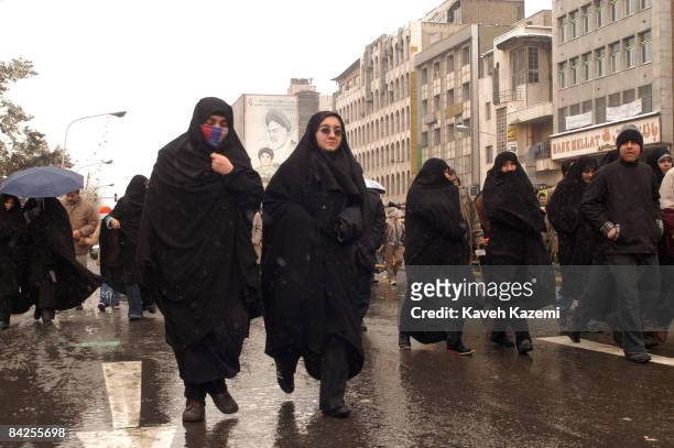 People march towards Azadi Square on a snowy day in Tehran commemorating the 26th anniversary of the Islamic Revolution, 10th February 2005. A huge...