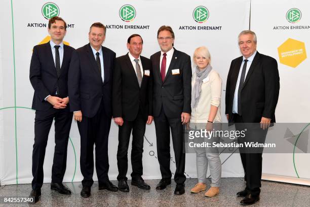 President Reinhard Grindel, DFB general secretary Dr. Friedrich Curtius and DFB vice president Peter Frymuth pose with members of the Football...
