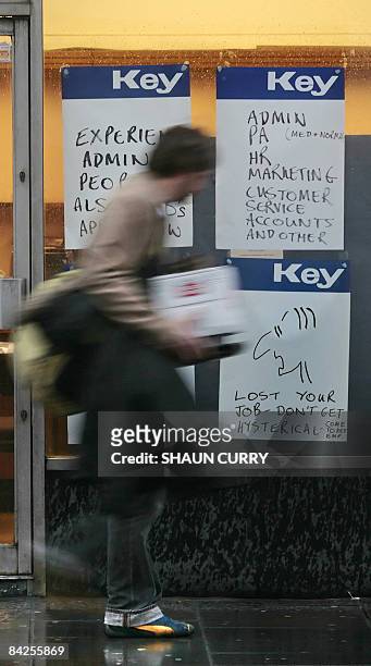 Man walks past a recruitment company window displaying job vacancies in southwest London, on January 12, 2009. Prime Minister Gordon Brown on Monday...