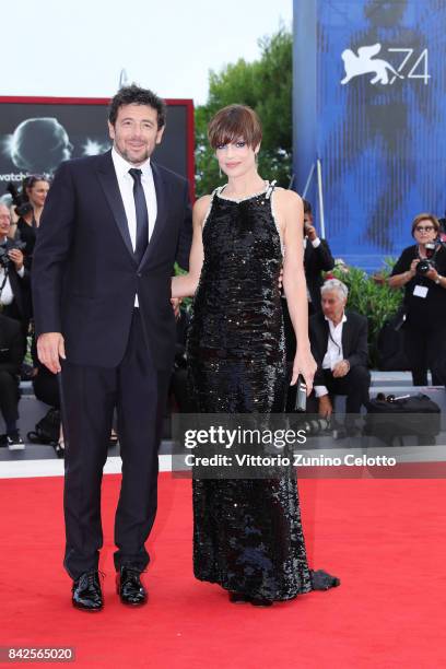 Patrick Bruel and Micaela Ramazzoti walk the red carpet ahead of the 'Una Famiglia' screening during the 74th Venice Film Festival at Sala Grande on...