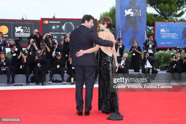 Patrick Bruel and Micaela Ramazzoti walk the red carpet ahead of the 'Una Famiglia' screening during the 74th Venice Film Festival at Sala Grande on...