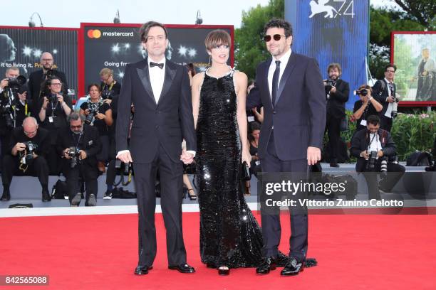 Patrick Bruel, Micaela Ramazzotti and Sebastiano Riso walk the red carpet ahead of the 'Una Famiglia' screening during the 74th Venice Film Festival...