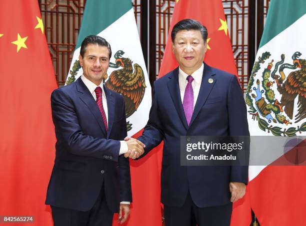 China's president Xi Jinping and Mexican President Enrique Pena Nieto shake hands following their meeting during the Brazil, Russia, India, China,...