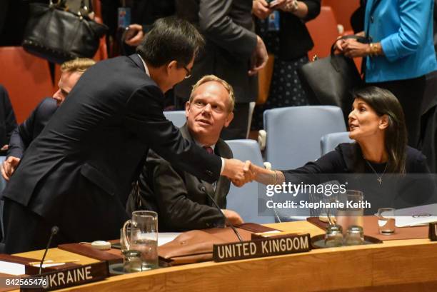 South Korean Ambassador Cho Tae-Yul shakes hands with Ambassador to the UN, Nikki Haley after a United Nations Security Council meeting on North...