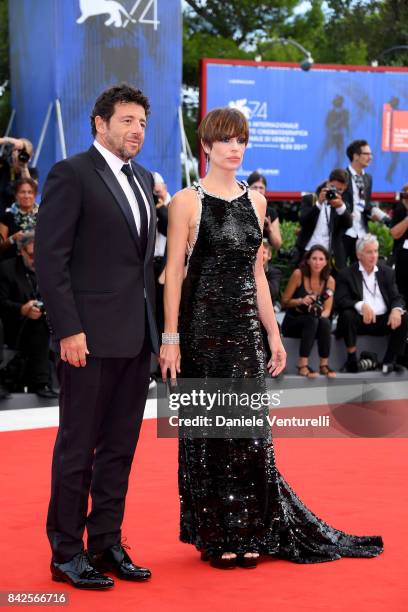 Micaela Ramazzoti and Patrick Bruel walk the red carpet ahead of the 'Una Famiglia' screening during the 74th Venice Film Festival at Sala Grande on...