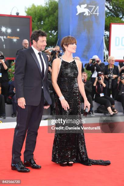 Micaela Ramazzoti and Patrick Bruel walk the red carpet ahead of the 'Una Famiglia' screening during the 74th Venice Film Festival at Sala Grande on...