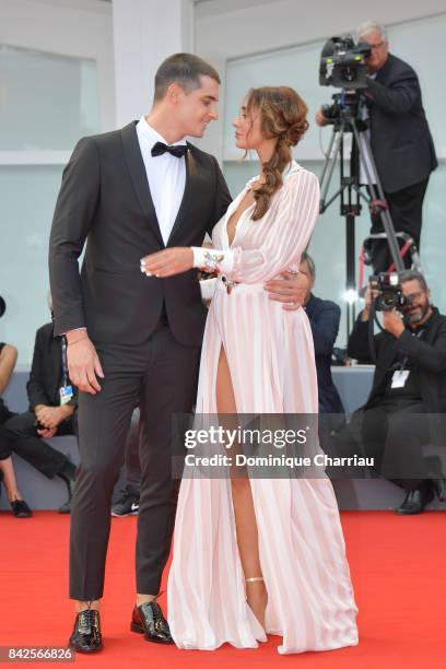 Emanuele Mauti and Sonia Lorenzini walk the red carpet ahead of the 'Una Famiglia' screening during the 74th Venice Film Festival at Sala Grande on...