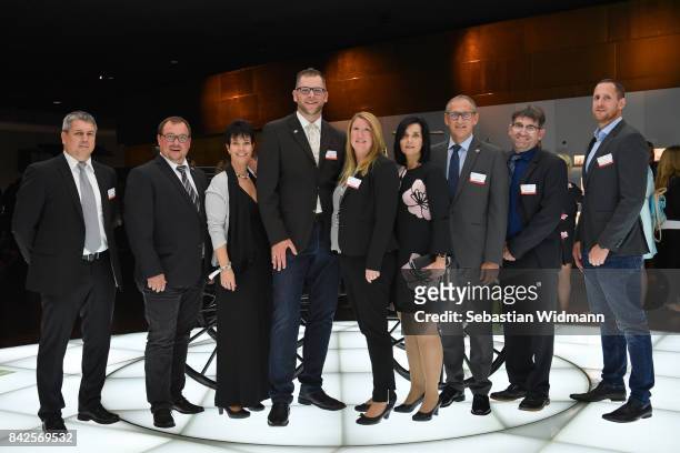 Guests pose for a picture during the Awarding Ceremony at the 20th anniversary of Volunteering for the Club 100 at Mercedes-Benz Museum on September...