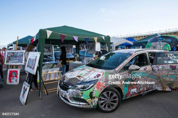 Vauxhall car decorated by the Artist Kristjana S Williams parked next to her stall at the 2017 Art Car Boot Fair, Folkestone, Kent.
