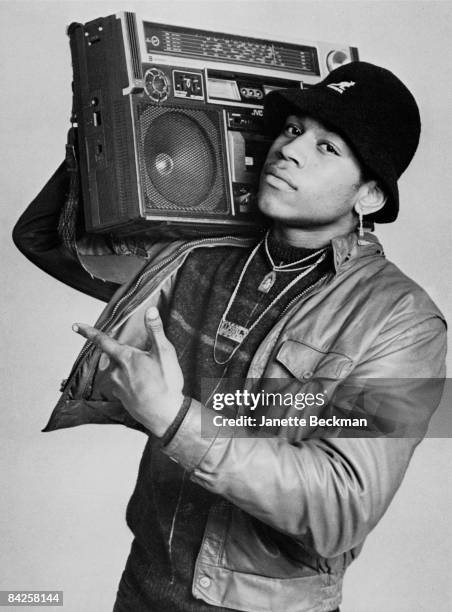 Rapper LL Cool J , real name James Todd Smith, carries a boombox upon his right shoulder while posing for a studio portrait, 1985 New York. He is...