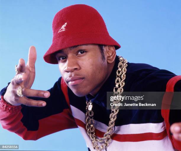 Rapper LL Cool J , real name James Todd Smith, posing for a studio portrait, 1986 New York. He is wearing a red Kangol Bermuda casual hat, a thick...