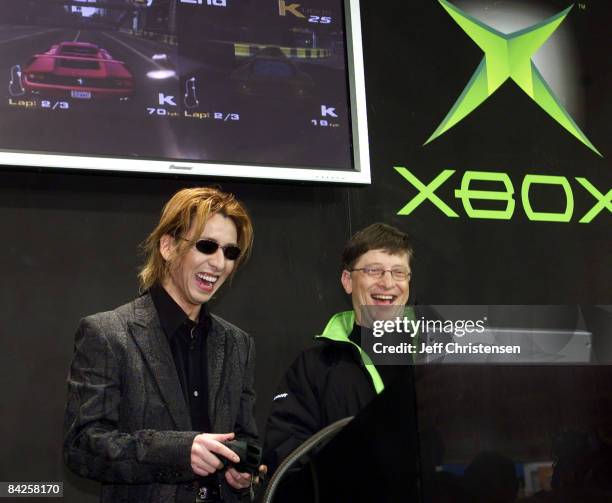 Microsoft Corp. Chairman Bill Gates plays a game on the Xbox video game system with Japanese rock star Yoshiki during an event held to launch Xbox in...