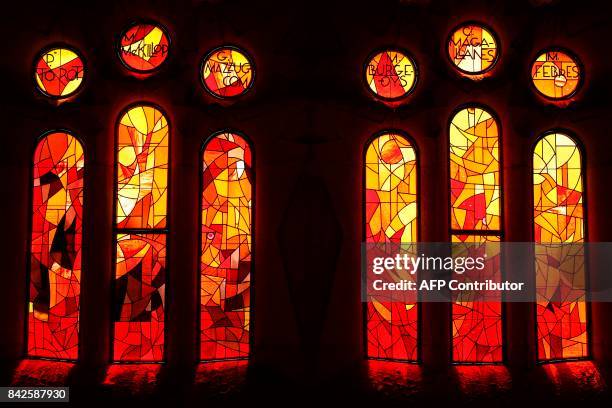 Light comes through stained-glass windows in the Expiatory Church of the "Sagrada Familia" basilica, designed by Spanish architect Antoni Gaudi, in...
