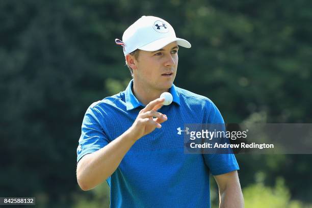 Jordan Spieth of the United States acknowledges fans after making his eagle putt on the second green during the final round of the Dell Technologies...