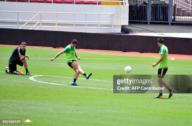 Mexico's coach Juan Carlos Osorio and player Javier Hernandez take part in a training at the National Stadium in San Jose on September 4, 2017 ahead...