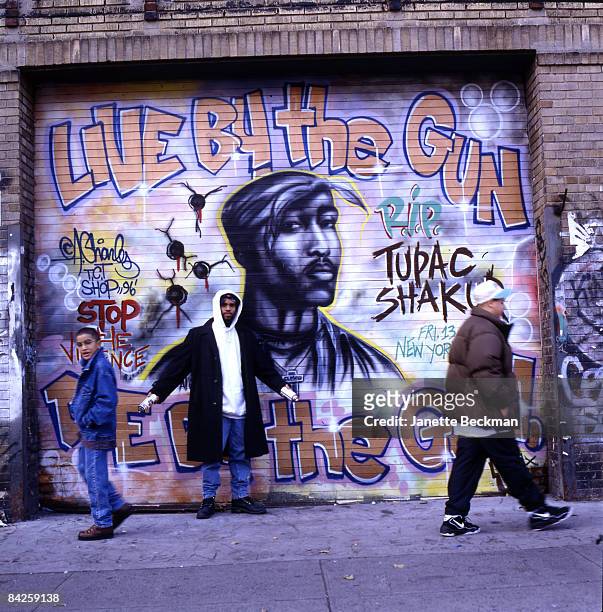 Noted graffiti artist Andre 'Baby Man' Charles stands before his tribute mural to rapper Tupac Shakur on on East Houston street in the Lower East...