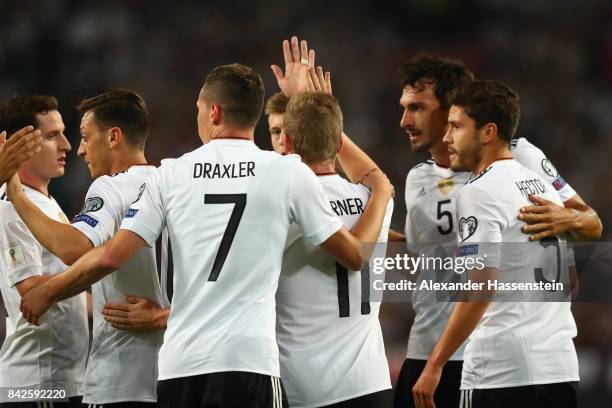 Mesut Oezil of Germany ) is celebrated by Julian Draxler of Germany and Jonas Hector of Germany after he scored Germany's first goal. During the FIFA...