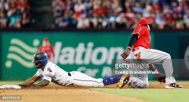 Delino DeShields of the Texas Rangers steals as second baseman Alfredo Griffin of the Los Angeles Angels of Anaheim is unable to make the tag during...