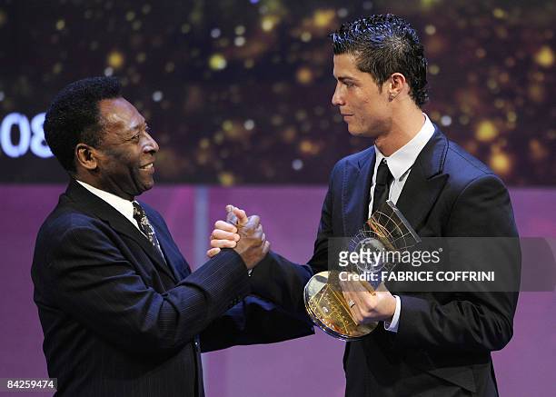 Portuguese football player Cristiano Ronaldo receives congratulations from Brazilian football legend Pele after recieving the FIFA world footballer...