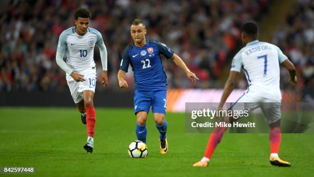 Stanislav Lobotka of Slovakia is watched by Dele Alli and Marcus Rashford of England during the FIFA 2018 World Cup Qualifier between England and...