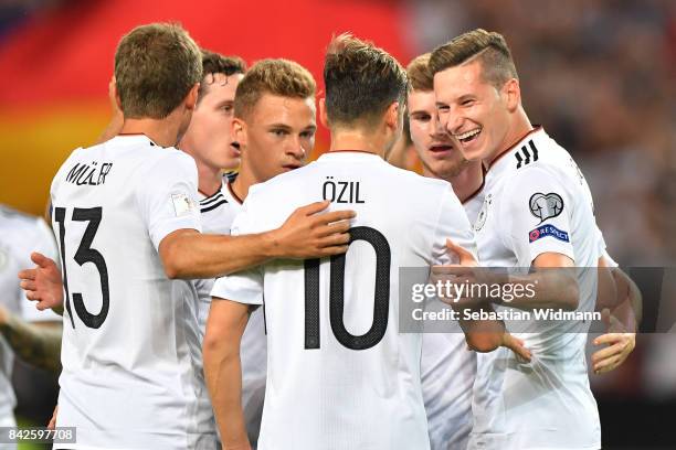 Julian Draxler of Germany celebrates with Mesut Oezil of Germany and Thomas Mueller of Germany after he scored to make it 2:0 during the FIFA 2018...