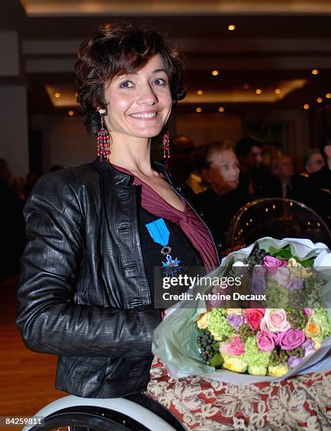 Pilot Dorine Bourneton poses after being presented with the Medaille de l'Ordre National du Merite by Minister of Transports, Dominqiue Bussereau, at...