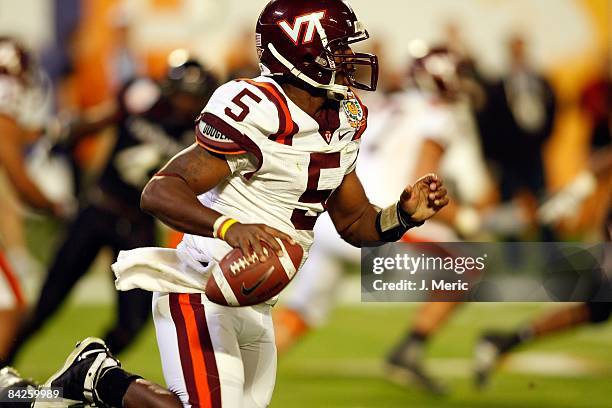 Quarterback Tyrod Taylor of the Virginia Tech Hokies runs the ball against the Cincinnati Bearcats during the FedEx Orange Bowl at Dolphin Stadium on...