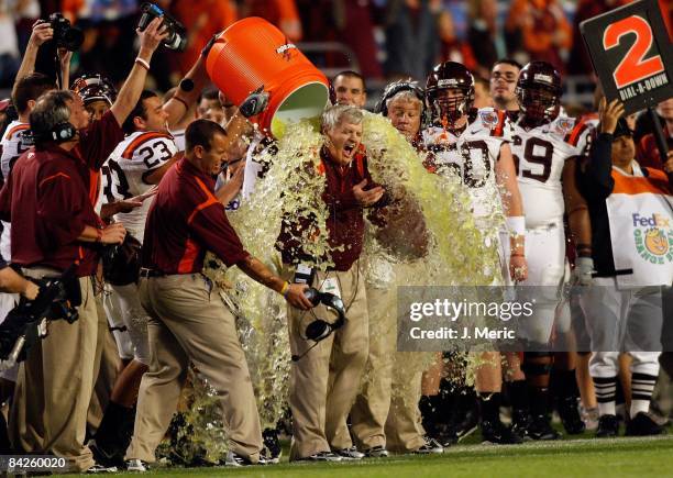 Head coach Frank Beamer of the Virginia Tech Hokies is doused along the sidelines against the Cincinnati Bearcats during the FedEx Orange Bowl at...