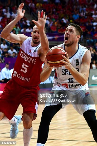 Serbia's centre Vladimir Stimac vies with Turkey's guard Sinan Guler during the FIBA Eurobasket 2017 men's group D basketball match between Serbia...