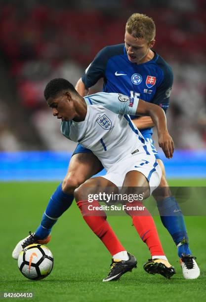 Marcus Rashford of England shields the ball from Tomas Hubocan of Slovakia during the FIFA 2018 World Cup Qualifier between England and Slovakia at...