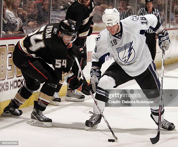 Adam Hall of the Tampa Bay Lighting battles for the puck against Bobby Ryan of the Anaheim Ducks during the game on January 9, 2009 at Honda Center...