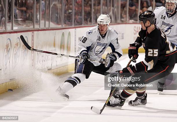 Adam Hall of the Tampa Bay Lighting chases the puck against Chris Pronger of the Anaheim Ducks during the game on January 9, 2009 at Honda Center in...