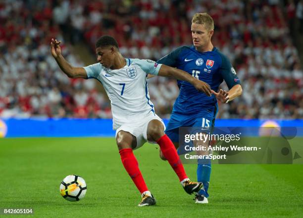 England's Marcus Rashford holds off the challenge from Slovakia's Tomas Hubocan during the FIFA 2018 World Cup Qualifier between England and Slovakia...